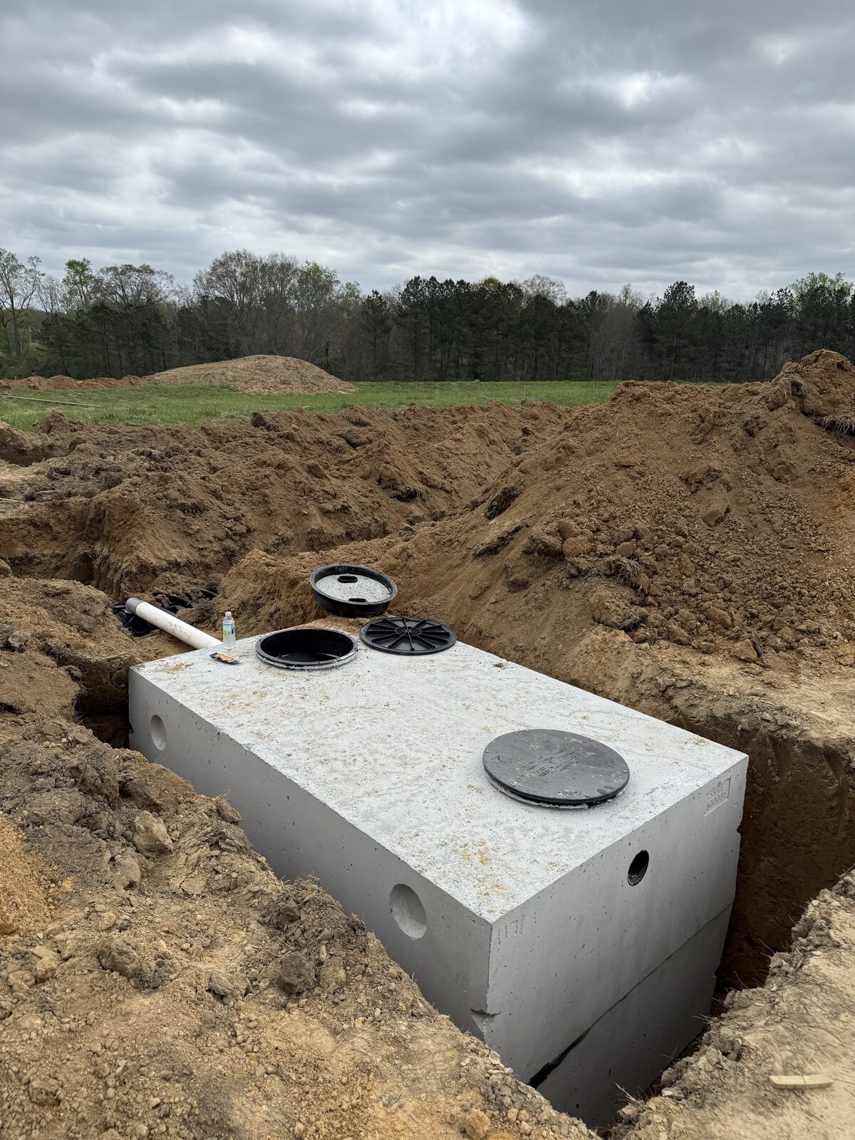 New concrete septic tank set in a rural field